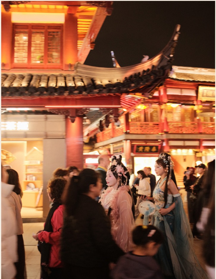 Performers in traditional dress at a night market