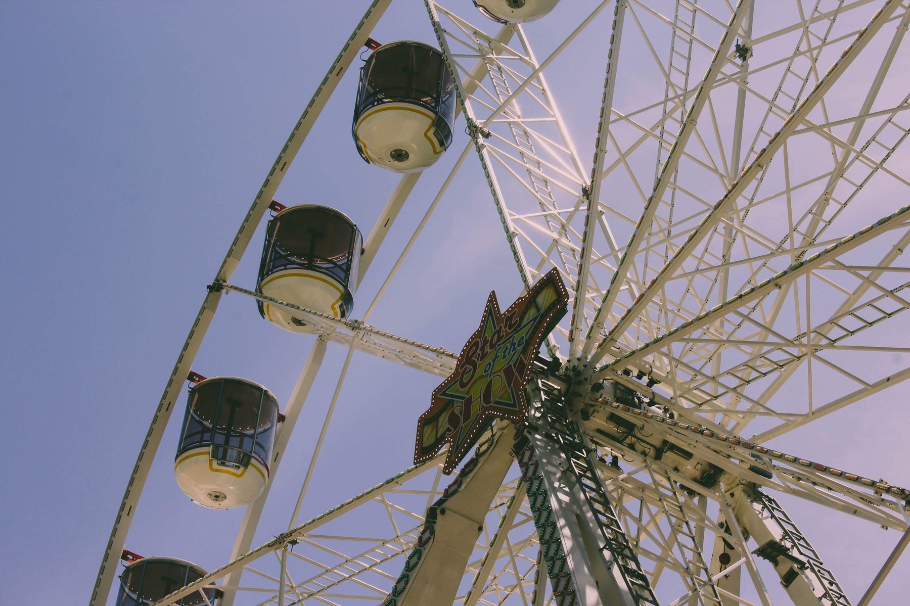 A ferris wheel against a pale sky